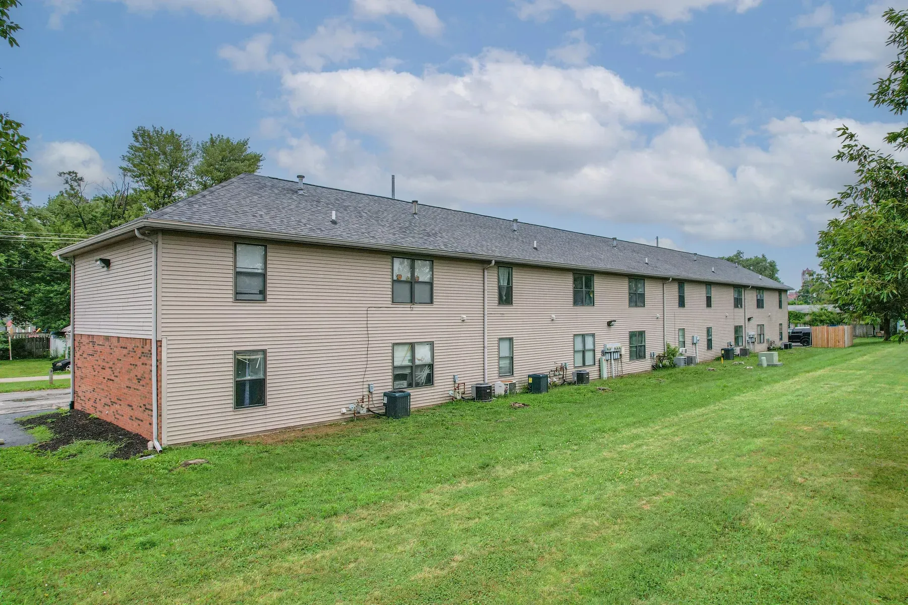Side view of the two-story Center Place Apartments building, Greenfield, with a grassy lawn