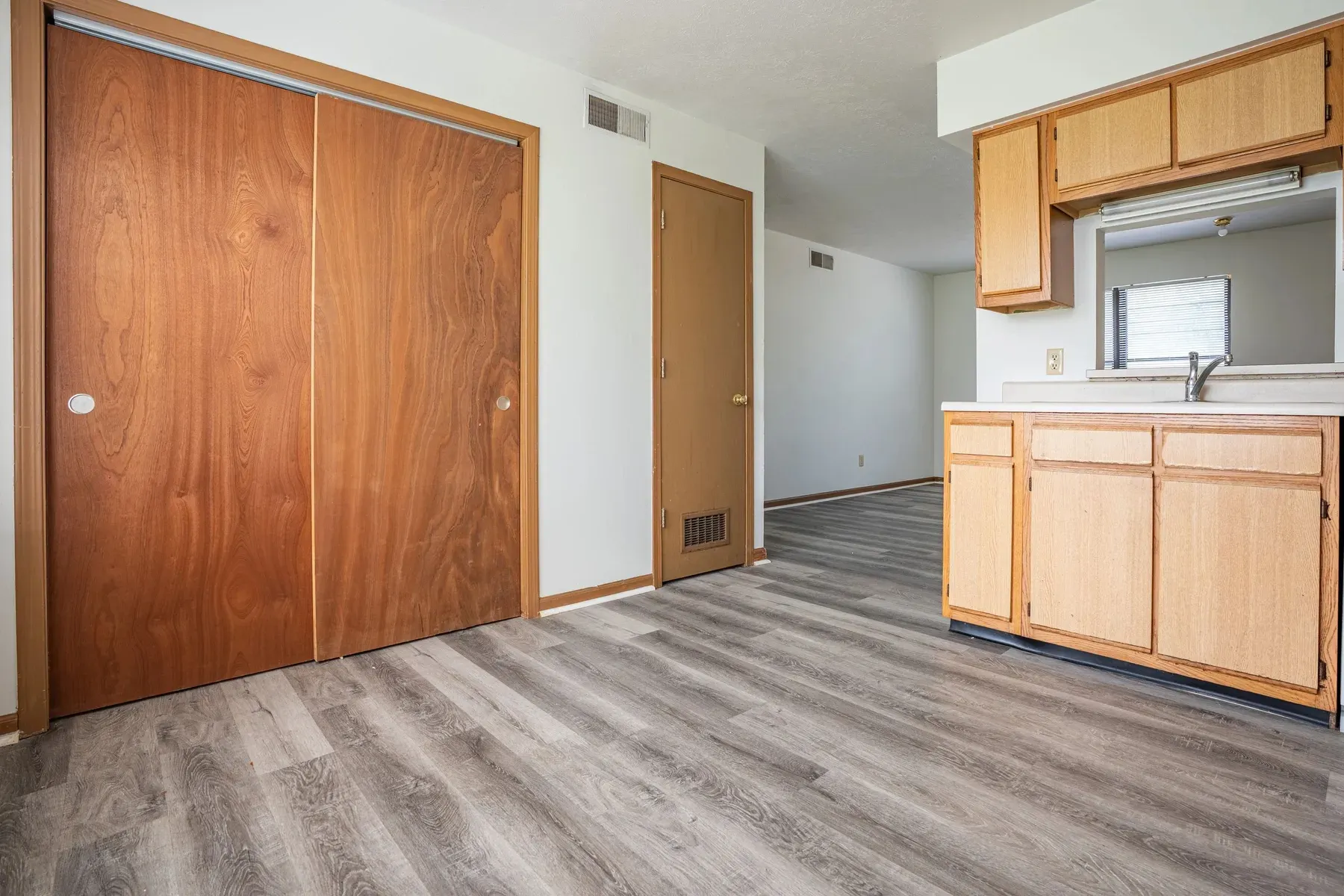 Apartment interior with wood-look flooring at Center Place Apartments, Greenfield