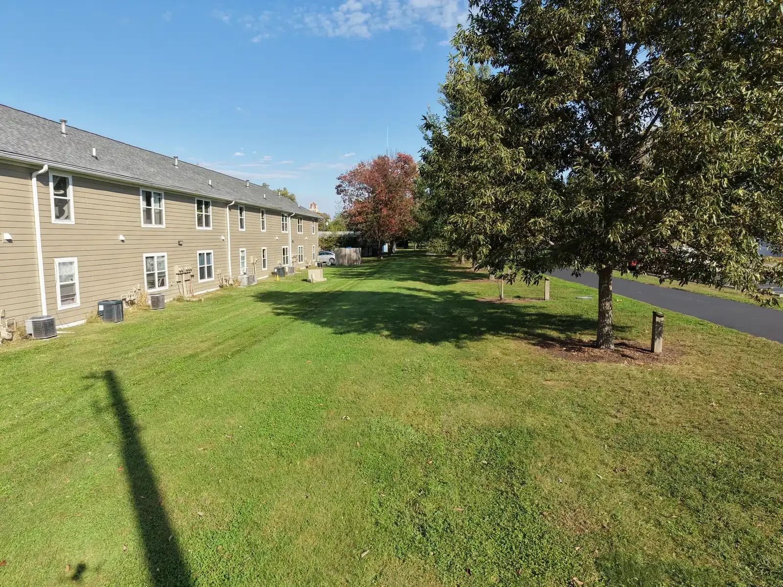 Back lawn and shade trees beside the Center Place Apartments building, Greenfield