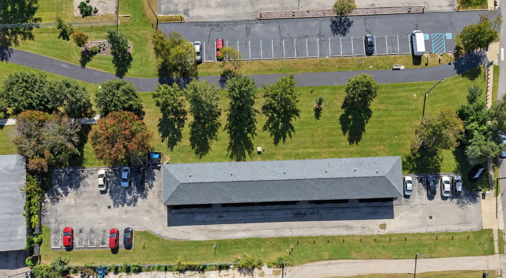 Overhead view of the Center Place Apartments building, its parking areas and lawn, Greenfield