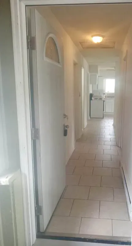 Tiled hallway inside a three-bedroom apartment at New Palestine Apartments, New Palestine
